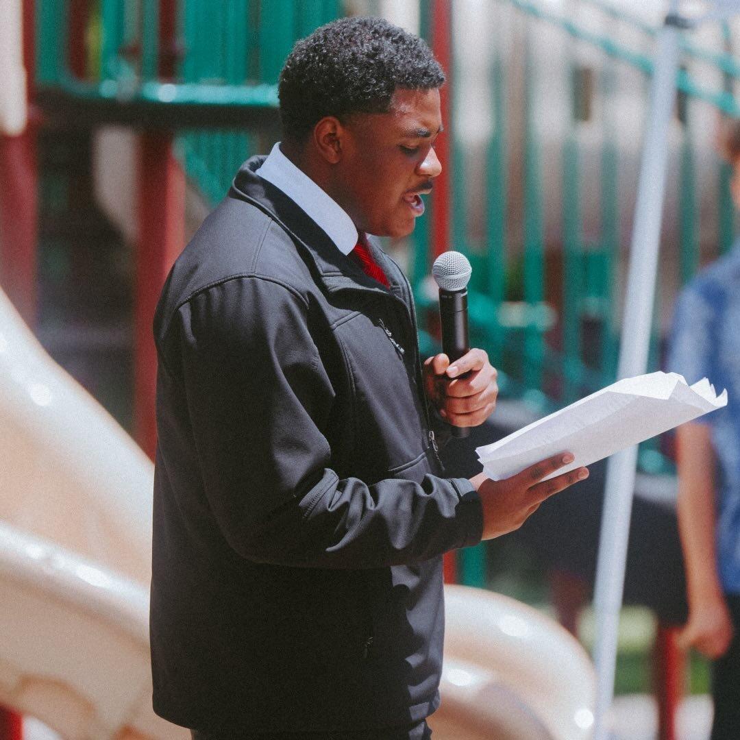 A young evangelist preaching the Gospel outdoors